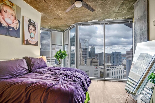 bedroom with hardwood / wood-style flooring, ceiling fan, and floor to ceiling windows