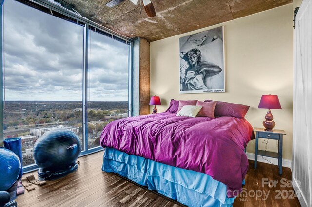 bedroom featuring hardwood / wood-style floors and ceiling fan