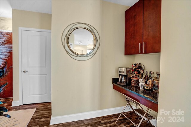 hall with dark wood-type flooring