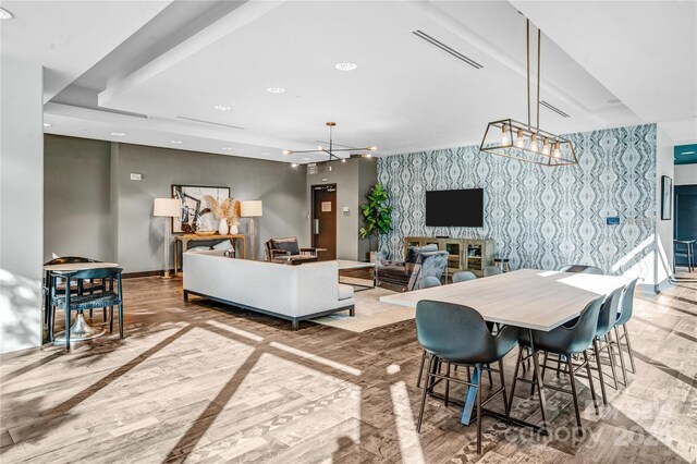 dining room featuring wood-type flooring and an inviting chandelier