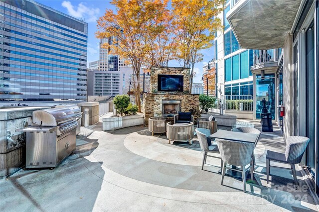 view of patio / terrace featuring an outdoor stone fireplace