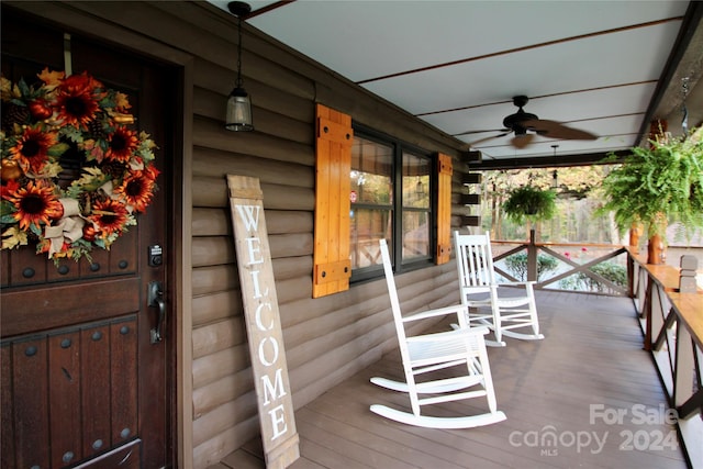 wooden terrace with covered porch and ceiling fan