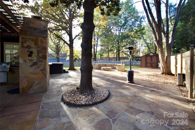 view of patio featuring a storage shed