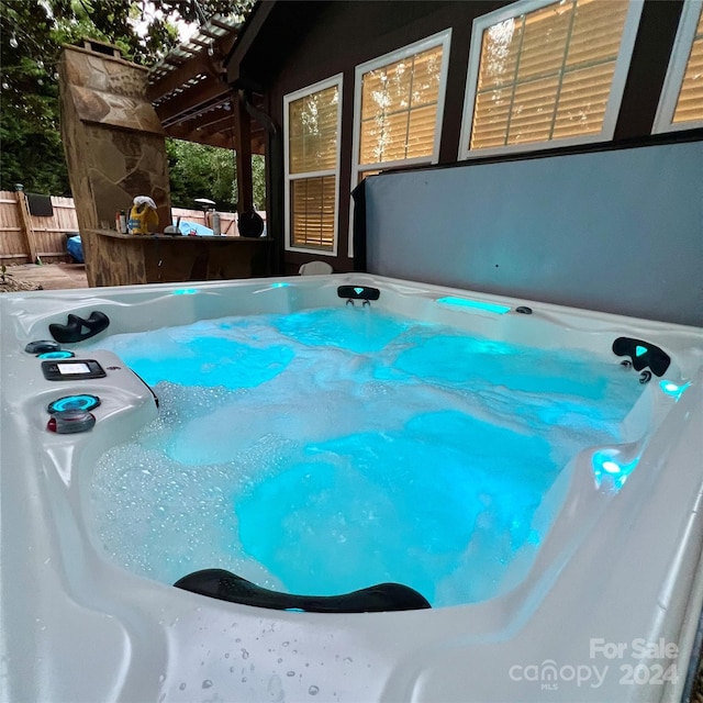 view of pool with a hot tub