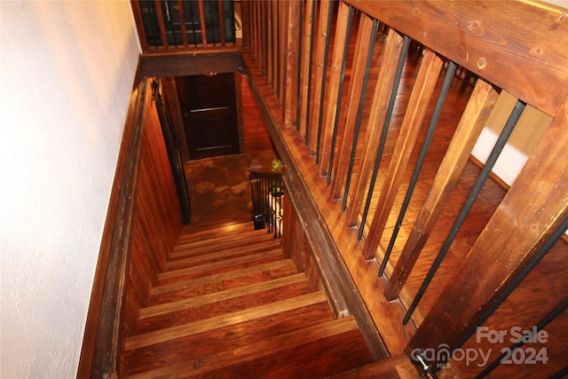 staircase featuring hardwood / wood-style floors