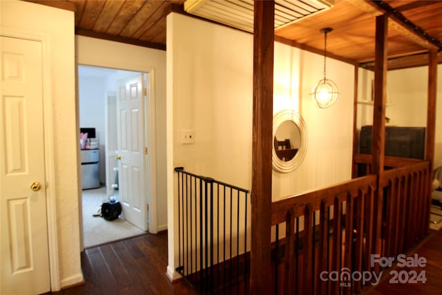 hall with dark hardwood / wood-style floors and wood ceiling