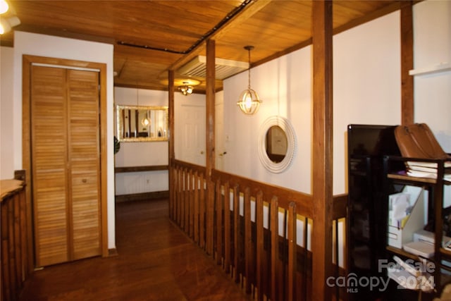 hall with dark hardwood / wood-style floors and wooden ceiling