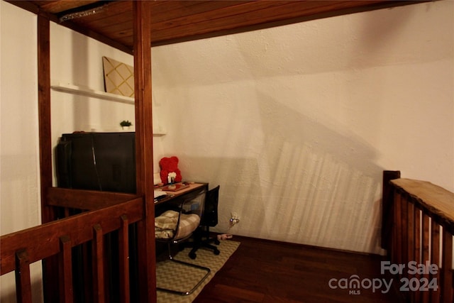 office space featuring dark hardwood / wood-style floors and wood ceiling