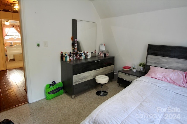 bedroom featuring wood-type flooring and vaulted ceiling