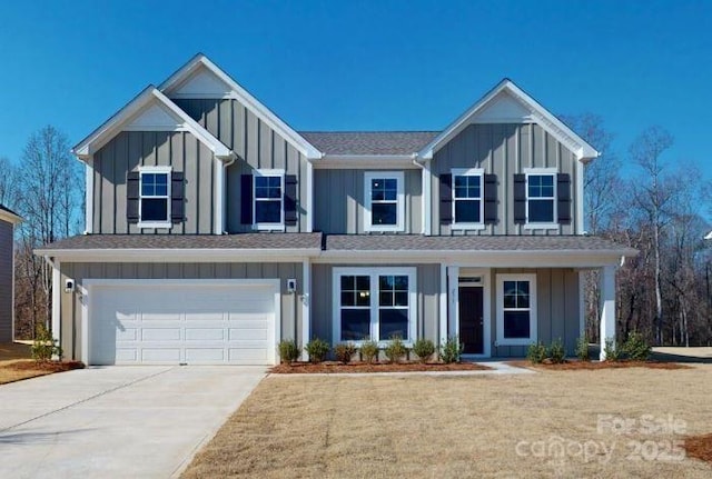 view of front of property featuring a garage, concrete driveway, and board and batten siding