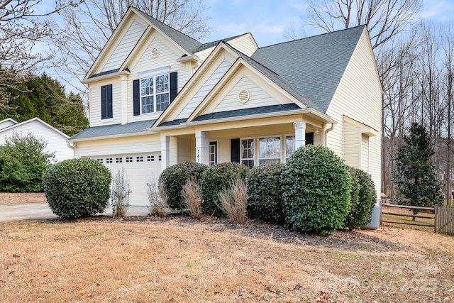 view of front of property with a garage and a front lawn