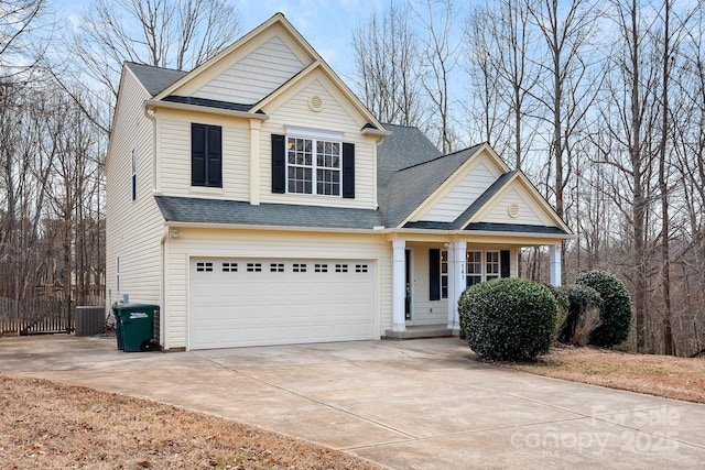 view of front property featuring a garage and central air condition unit