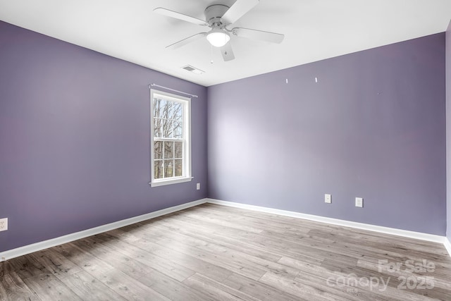 empty room with light hardwood / wood-style flooring and ceiling fan