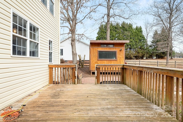 wooden deck featuring a storage shed