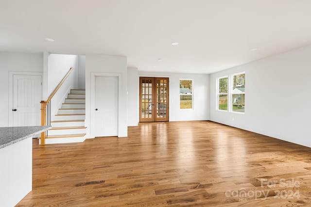 unfurnished living room with hardwood / wood-style floors