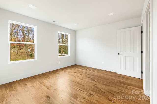 empty room featuring hardwood / wood-style floors and a healthy amount of sunlight