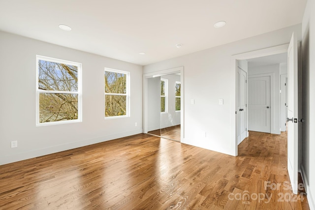 spare room with wood-type flooring