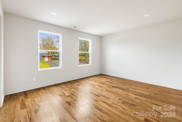 unfurnished room with light wood-type flooring