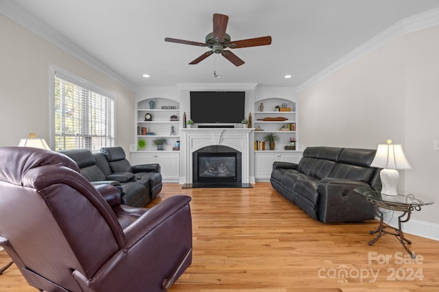 living room with crown molding, light hardwood / wood-style flooring, ceiling fan, and built in features