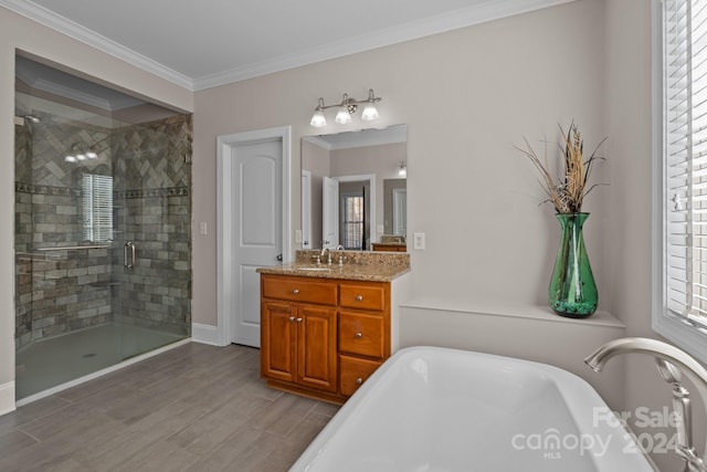 bathroom with crown molding, vanity, and shower with separate bathtub