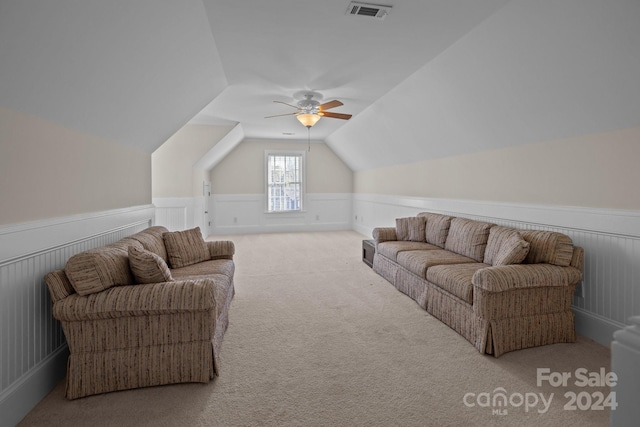 living room with carpet flooring, ceiling fan, and lofted ceiling