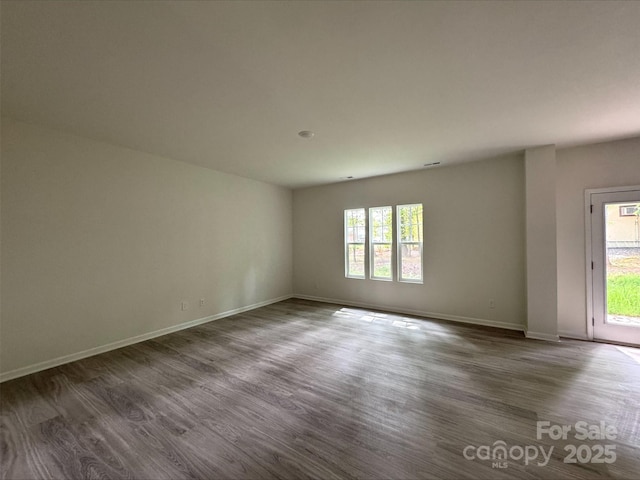 164 Wildwood Loop, Statesville, NC 28677 - unfurnished room with dark wood finished floors, a wealth of natural light, and baseboards