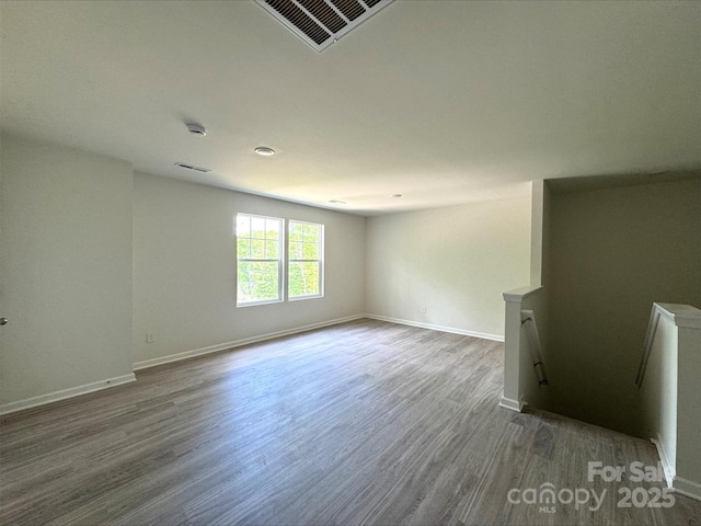 164 Wildwood Loop, Statesville, NC 28677 - spare room with wood finished floors, visible vents, and baseboards