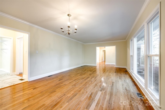 unfurnished room with a notable chandelier, crown molding, and light hardwood / wood-style flooring