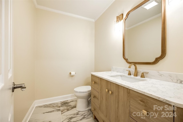 bathroom with toilet, vanity, and ornamental molding