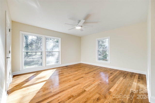 spare room featuring ceiling fan and light hardwood / wood-style floors