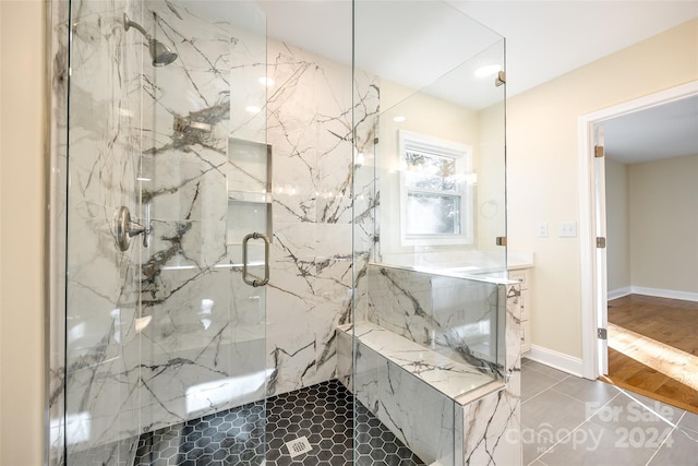 bathroom featuring wood-type flooring and an enclosed shower