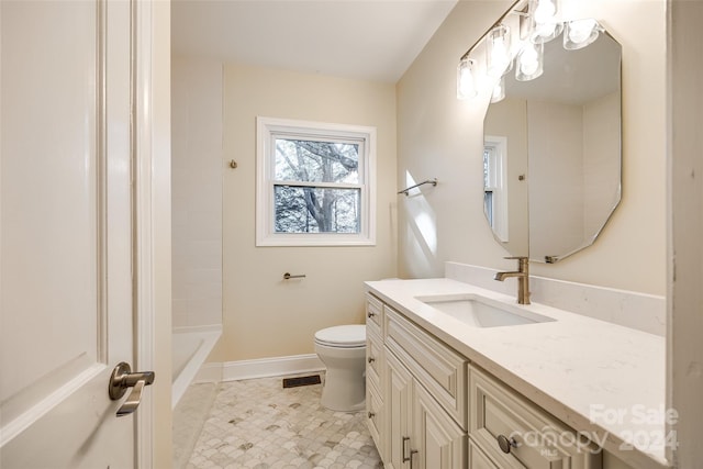 bathroom featuring tile patterned floors, vanity, and toilet