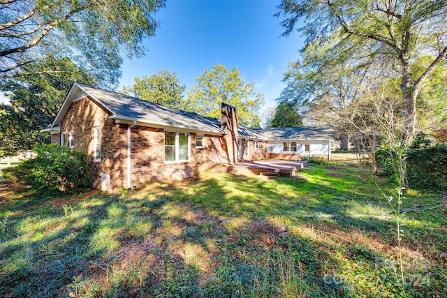 back of house with a lawn