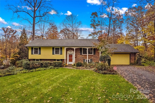 split foyer home with a front yard and a garage