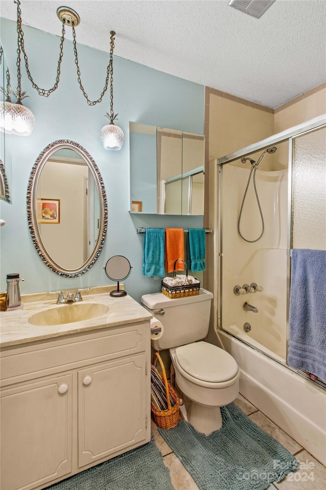 full bathroom featuring tile patterned flooring, a textured ceiling, toilet, and enclosed tub / shower combo