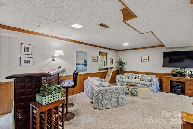 carpeted living room featuring a textured ceiling, crown molding, and wooden walls