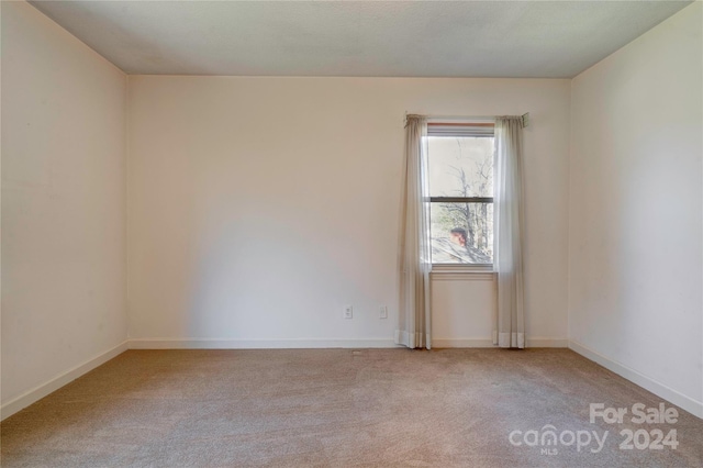 unfurnished room with carpet flooring