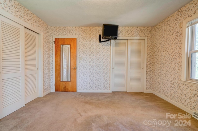 unfurnished bedroom with carpet floors