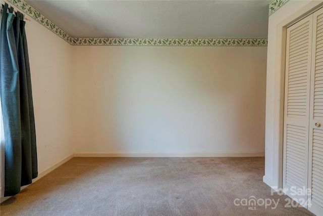 unfurnished bedroom with a closet and carpet