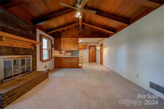 unfurnished living room featuring ceiling fan, wooden ceiling, vaulted ceiling with beams, light carpet, and a fireplace