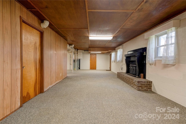 basement with carpet flooring and wood walls