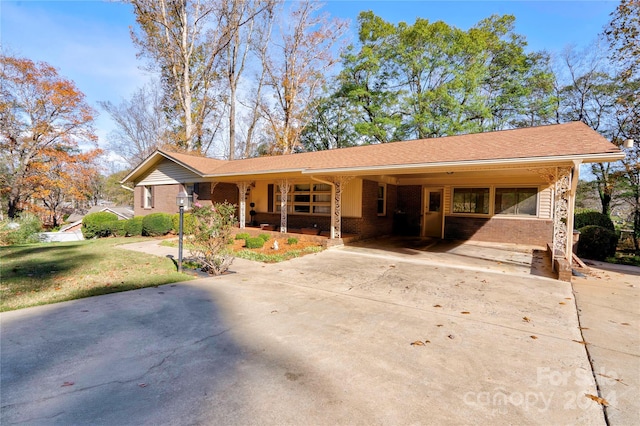 ranch-style house with a carport and a front lawn