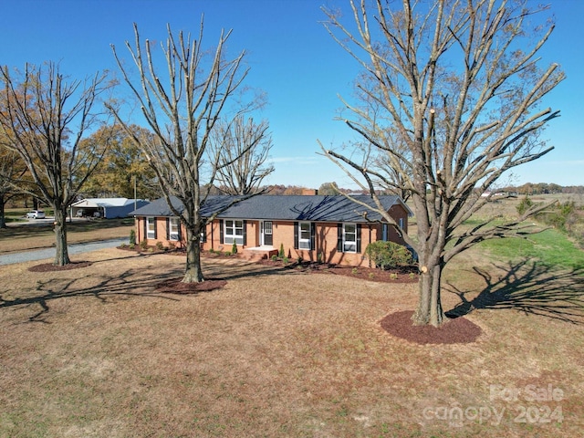 ranch-style house with a front lawn