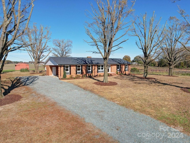 ranch-style home featuring a front yard