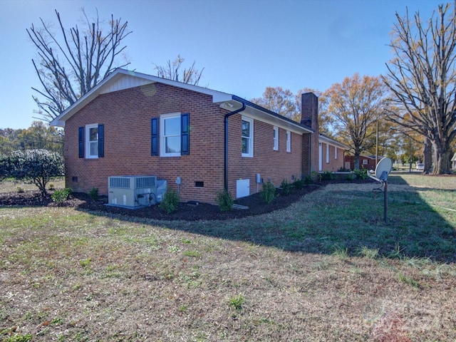 view of home's exterior with a yard and central AC unit