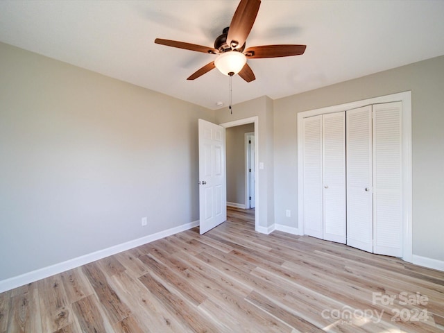 unfurnished bedroom featuring light wood-type flooring, a closet, and ceiling fan