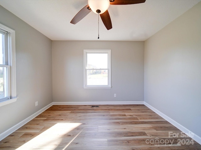 unfurnished room featuring ceiling fan and light wood-type flooring