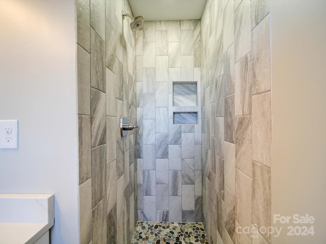 bathroom with a tile shower