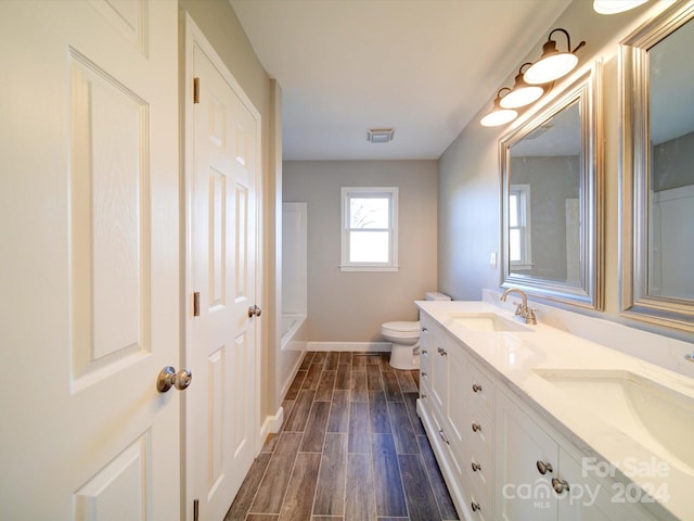 bathroom with hardwood / wood-style floors, vanity, and toilet