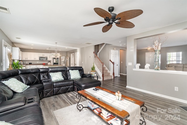 living room with hardwood / wood-style floors and ceiling fan